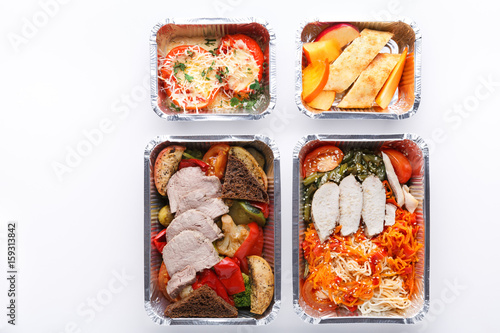 Healthy food take away in containers, top view on white background