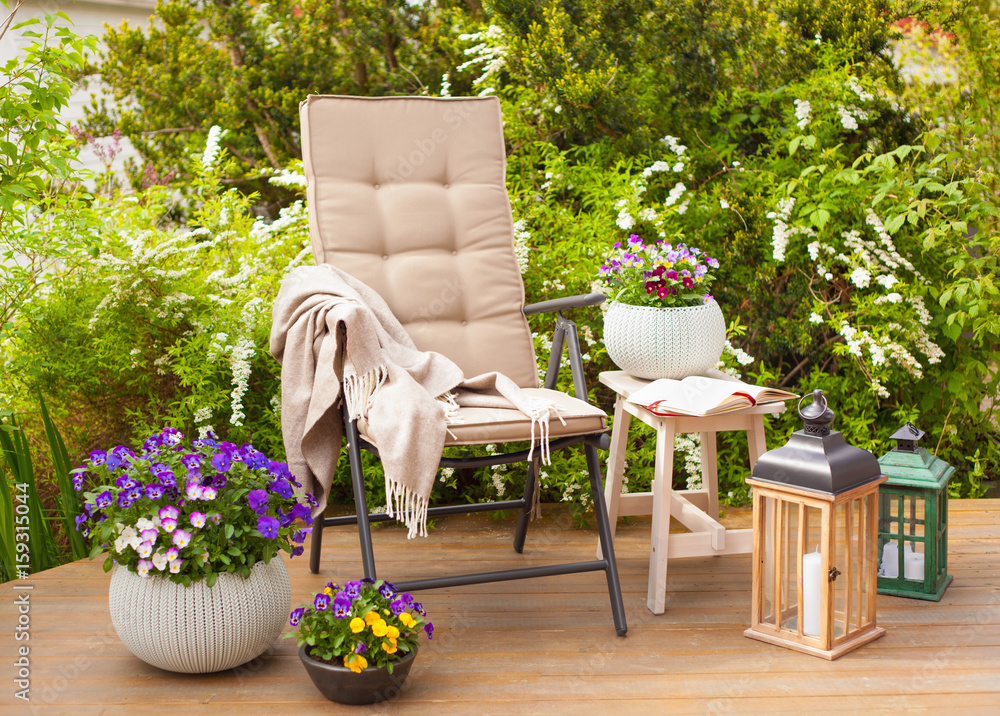 garden chair and table on terrace flowers bush