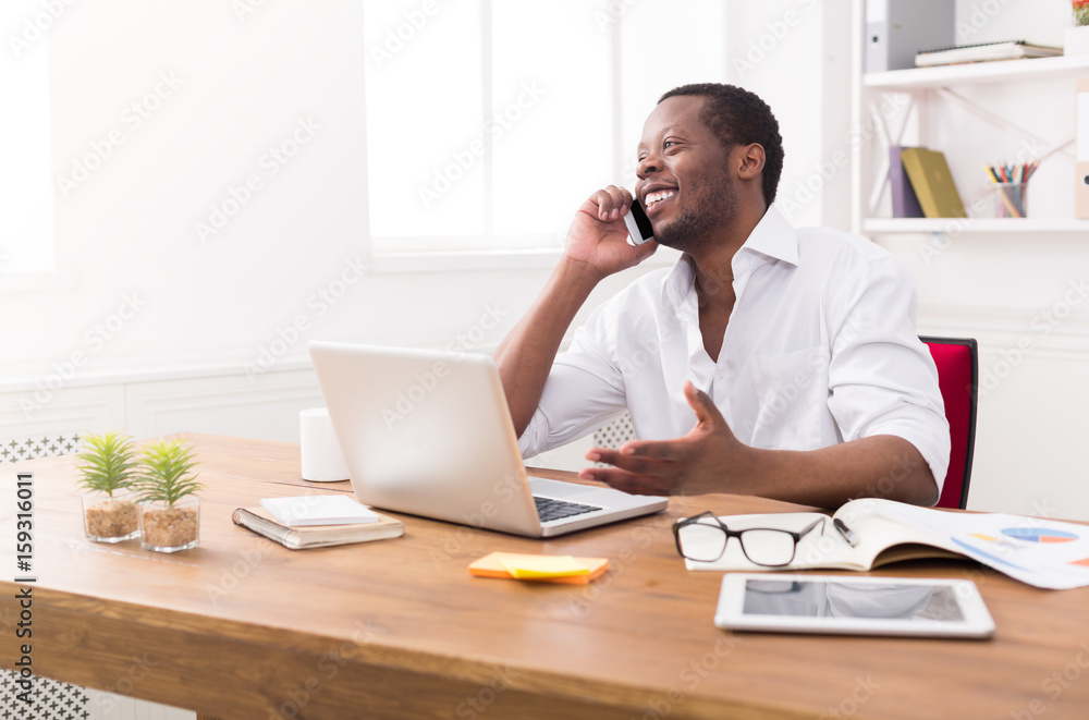 Young black businessman call mobile phone in modern white office Young black businessman call mobile phone in modern white office