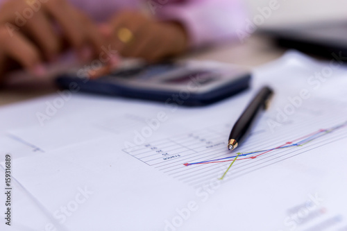 Concept business finance , Close up Coin and pen on summary report and calculator on table. © KPs Photography 