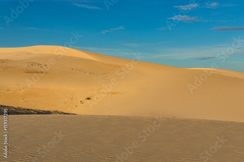 Desert sand dunes road at sunset