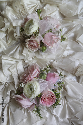 Pink and White Wedding Corsages on a Ruffled Fabric