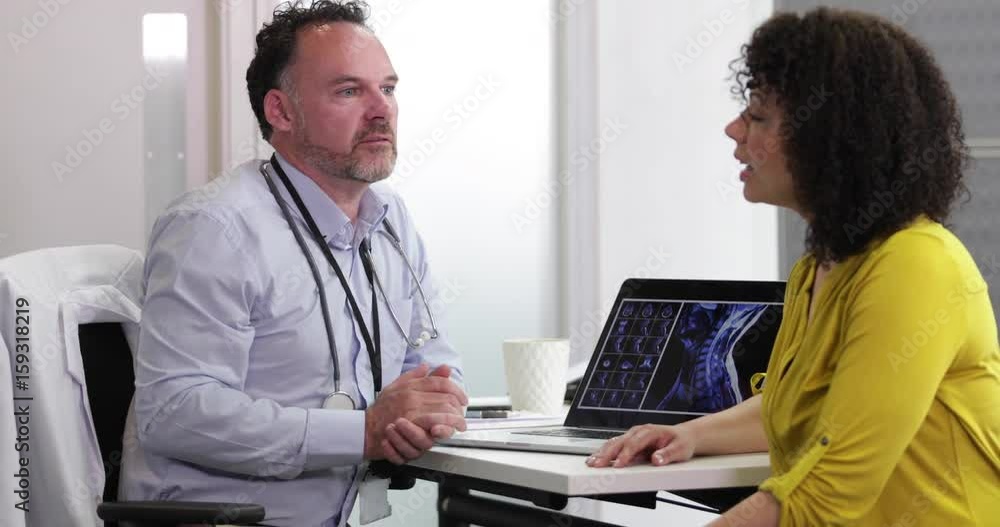 Male Medical Doctor explaining xray results to patient Male Medical Doctor explaining xray results to patient