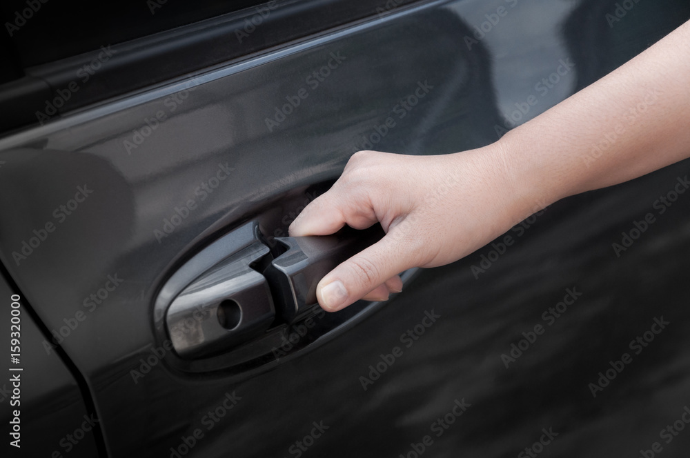 Woman hand open car door,hand pulling a car's door handle