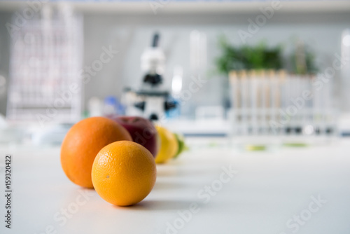 Fototapeta Naklejka Na Ścianę i Meble -  Scientific tools and fruits at workplace in modern biological laboratory