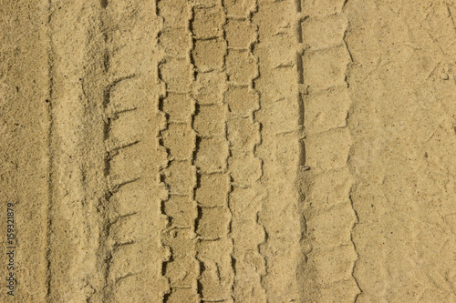 Trace of tire on a sand . Sand texture