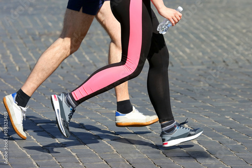 athletes run marathons on the pavement
