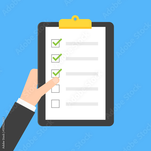 Hand holding clipboard checklist