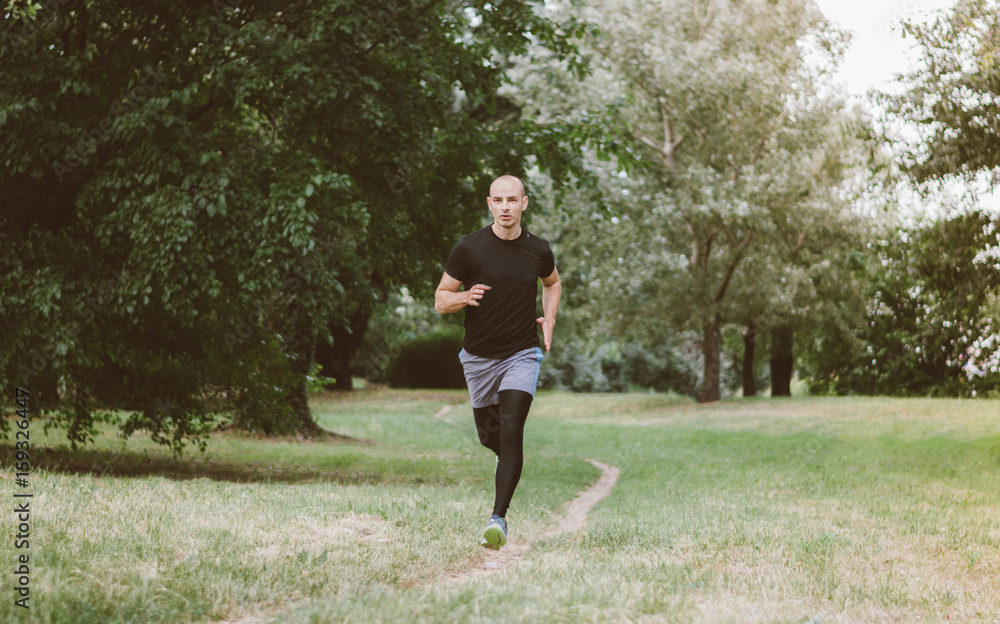 Man running jogging outdoors in nature Man running jogging outdoors in nature