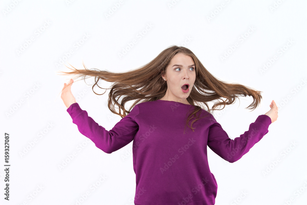 Surprised woman, woman in shock, surprise and flying hair. Blowing hair. Beautiful young girl posing in studio, human facial expressions and emotions. Surprised woman, woman in shock, surprise and flying hair. Blowing hair. Beautiful young girl posing in studio, human facial expressions and emotions.