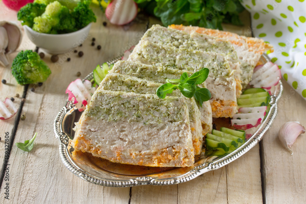 Meat casserole with minced meat, broccoli and carrots on the kitchen table with fresh vegetables. The concept of a healthy diet. Meat casserole with minced meat, broccoli and carrots on the kitchen table with fresh vegetables. The concept of a healthy diet.