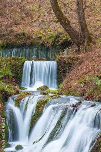 Shiraito Waterfall in autumn season , is located in the forests north of downtown Karuizawa , Japan