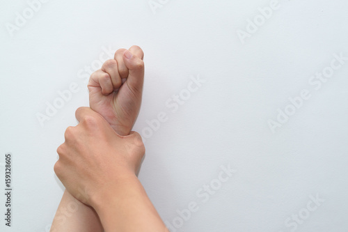Man hand oppressing or pressing woman wrist on the wall - woman violence concept.