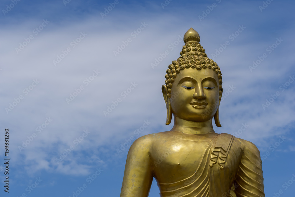 Golden Buddha Statue in Phuket; Thailand with blue sky background Golden Buddha Statue in Phuket; Thailand with blue sky background