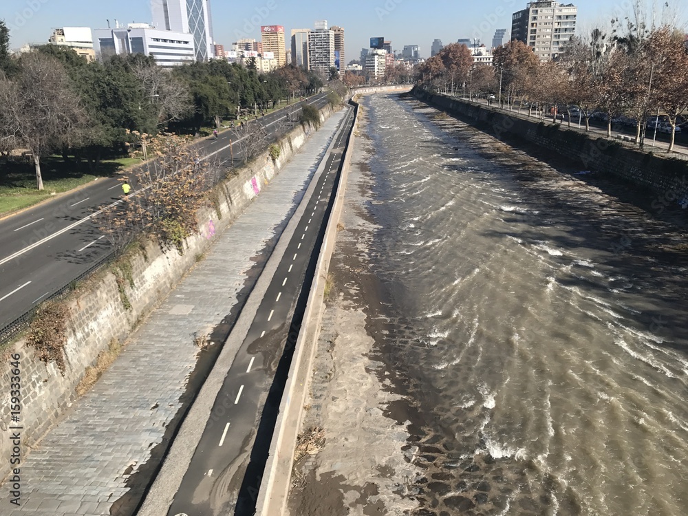 People cycling along a river in Santiago, Chile
