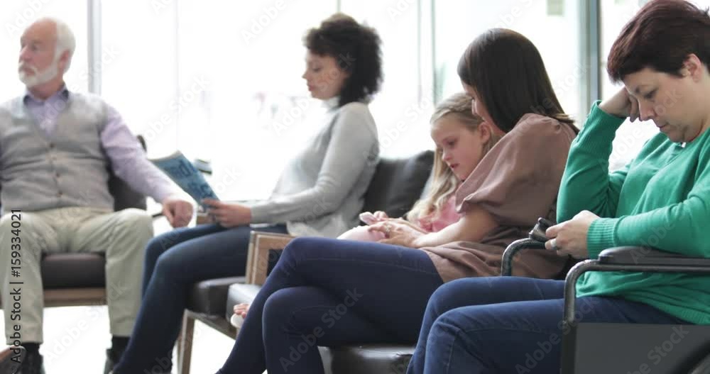 Patients waiting in a crowded hospital waiting room Patients waiting in a crowded hospital waiting room