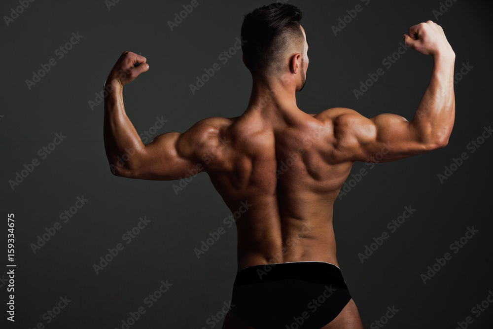 biceps and triceps of athlete with muscular body