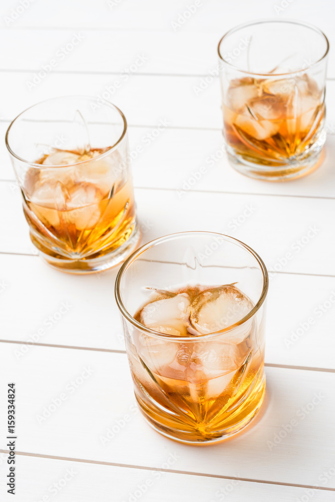 Whiskey glasses on white wooden table. Close up Whiskey glasses on white wooden table. Close up