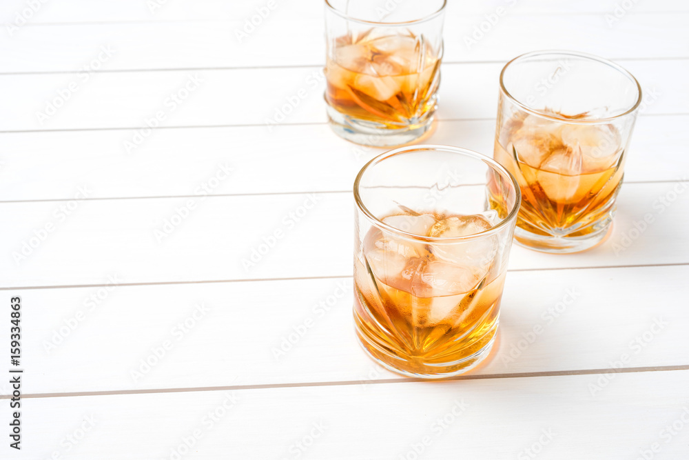 Whiskey glasses on white wooden table. Close up Whiskey glasses on white wooden table. Close up