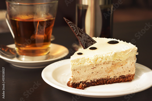 Cheesecake cake decorated with chocolate and tea