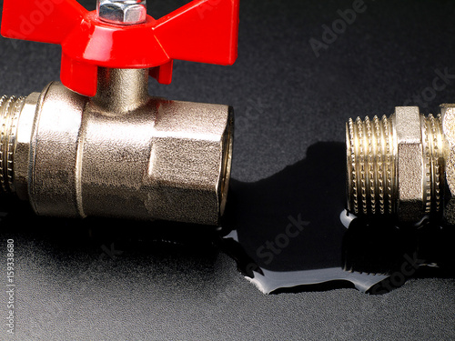 water leaking from disconnected valve and fitting, closeup