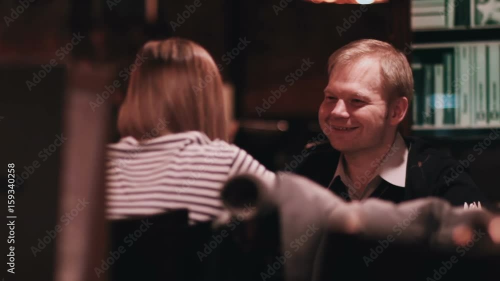 Young man with a girl is sitting in a cafe close-up Young man with a girl is sitting in a cafe close-up