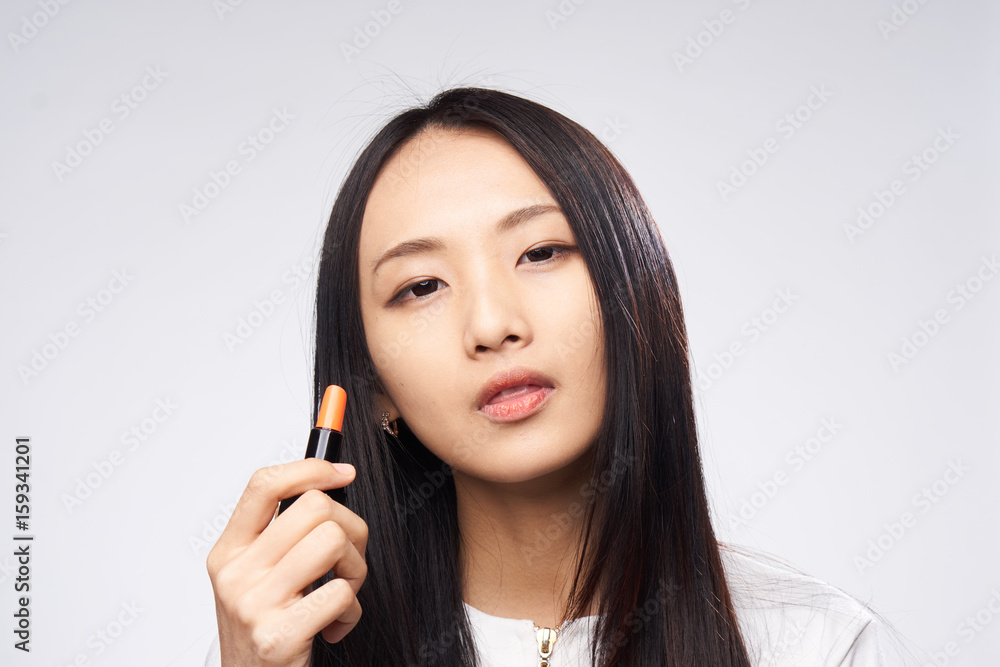 Woman asian paints makeup on face skin, woman enjoys makeup Woman asian paints makeup on face skin, woman enjoys makeup