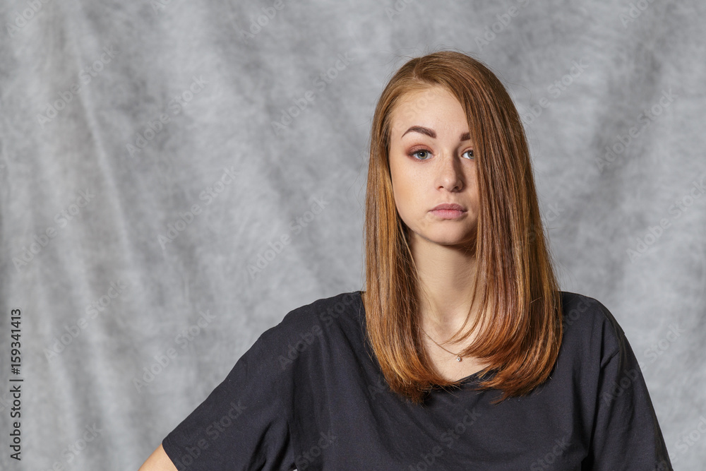 Girl at the age of nineteen poses on a light background Girl at the age of nineteen poses on a light background