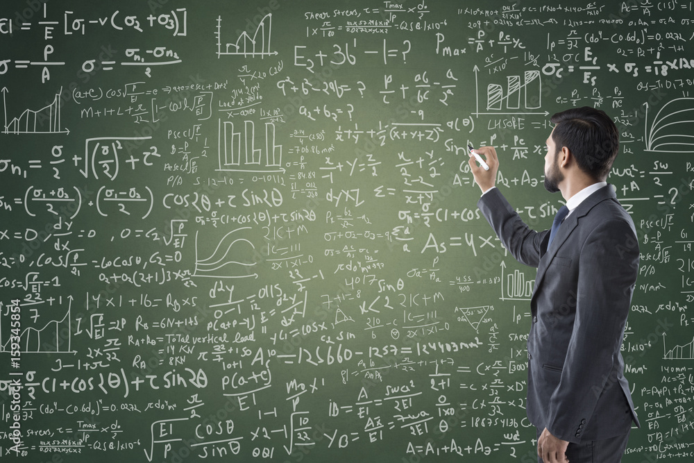 Portrait of businessman writing on blackboard Portrait of businessman writing on blackboard