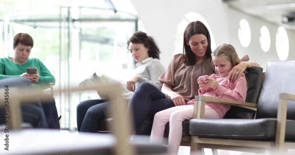 Women waiting in a crowded hospital waiting room Women waiting in a crowded hospital waiting room