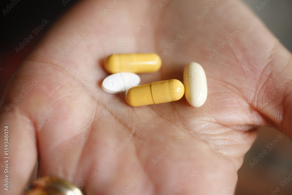 WOMAN TAKING MEDICATION WOMAN TAKING MEDICATION