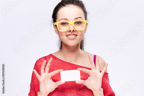 1032942 Woman with bright background. A woman with a white blank business card in her hands