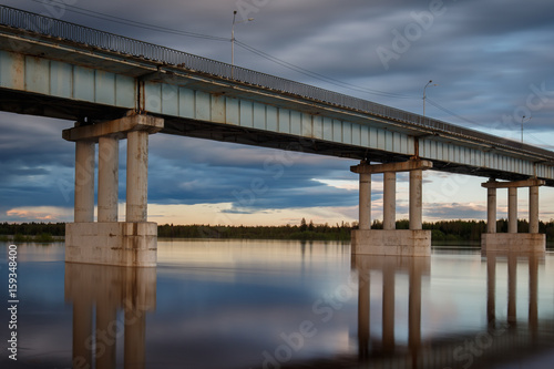 Common river bridge at cloudy day
