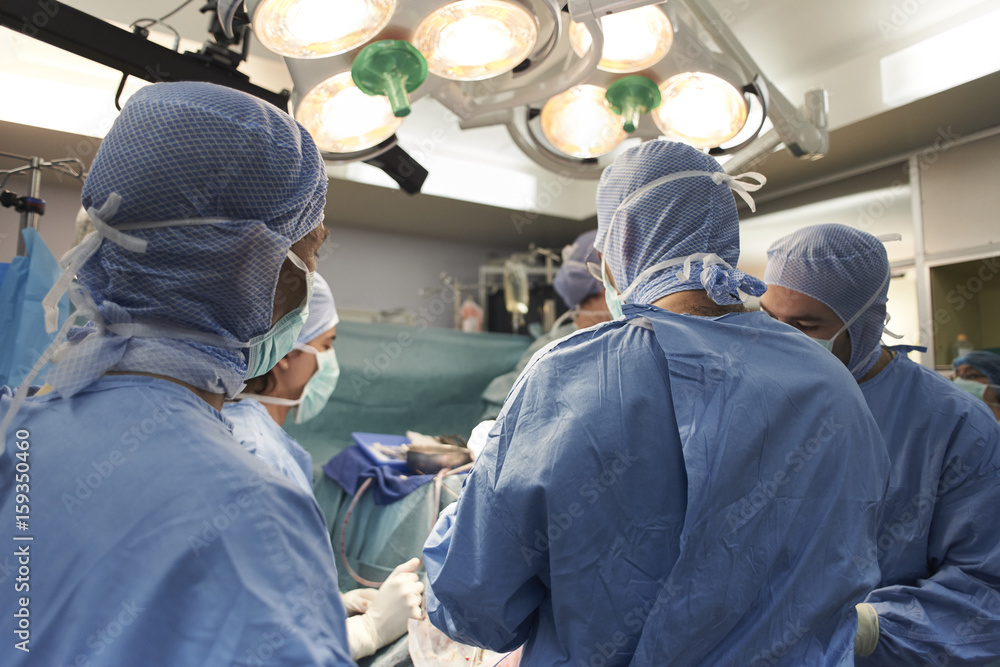 Doctors performing brain surgery on a child in operating room Doctors performing brain surgery on a child in operating room