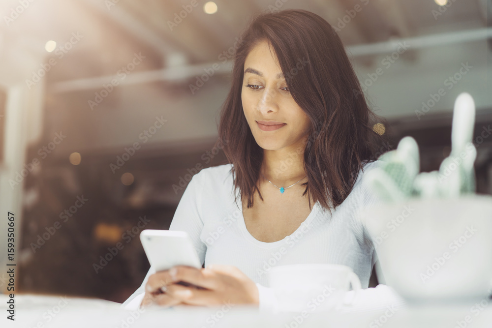Charming woman reading good news on mobile phone during rest at coffee shop, Blogger woman typing text message on smart phone while coffee break Charming woman reading good news on mobile phone during rest at coffee shop, Blogger woman typing text message on smart phone while coffee break