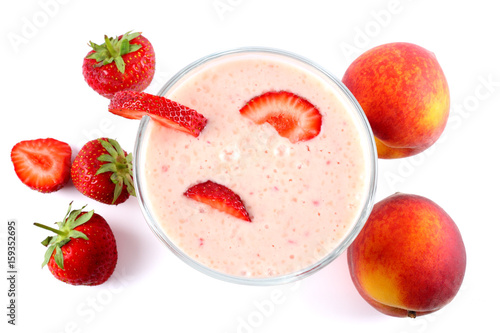Healthy strawberry yogurt with peach and mint leaves and fresh berries isolated on white background. Top view.
