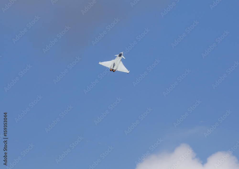 Modern jet fighter flying high in the sky. Afterburn glowing orange. Modern jet fighter flying high in the sky. Afterburn glowing orange.