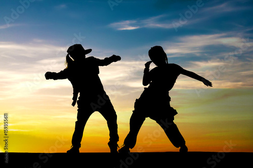 Obraz na plátně Fashion kids. Little girls dancing on sunset background.