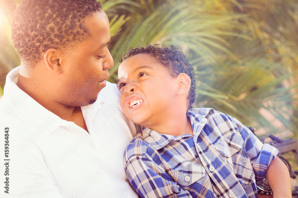 Fototapeta premium Mixed Race Son and African American Father Playing Outdoors Together.