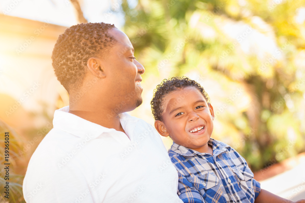 Mixed Race Son and African American Father Playing Outdoors Together. Mixed Race Son and African American Father Playing Outdoors Together.