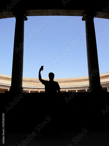 Silhouette of a man taking a picture on the Palace of Charles V © Bisual Photo
