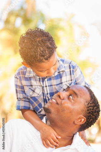 Mixed Race Son and African American Father Playing Outdoors Together.