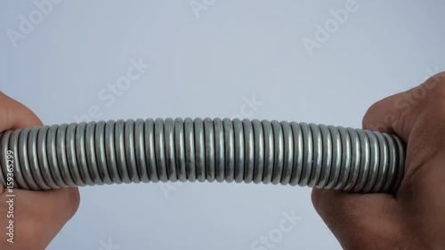 Man bends the spring with his hands