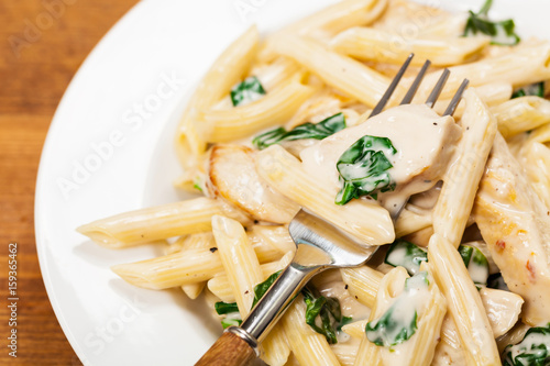 Chicken Alfredo Pasta with Spinach. Selective focus.