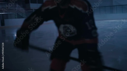Ice hockey player rides on ice in the dark