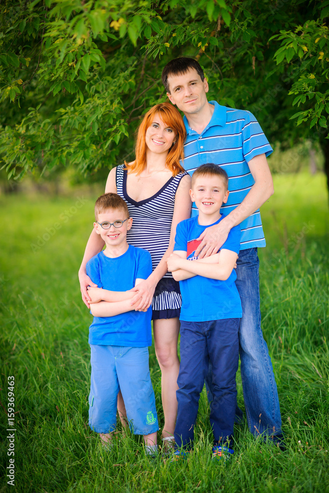 happy family on walk in the park, amicably embrace and smile happy family on walk in the park, amicably embrace and smile
