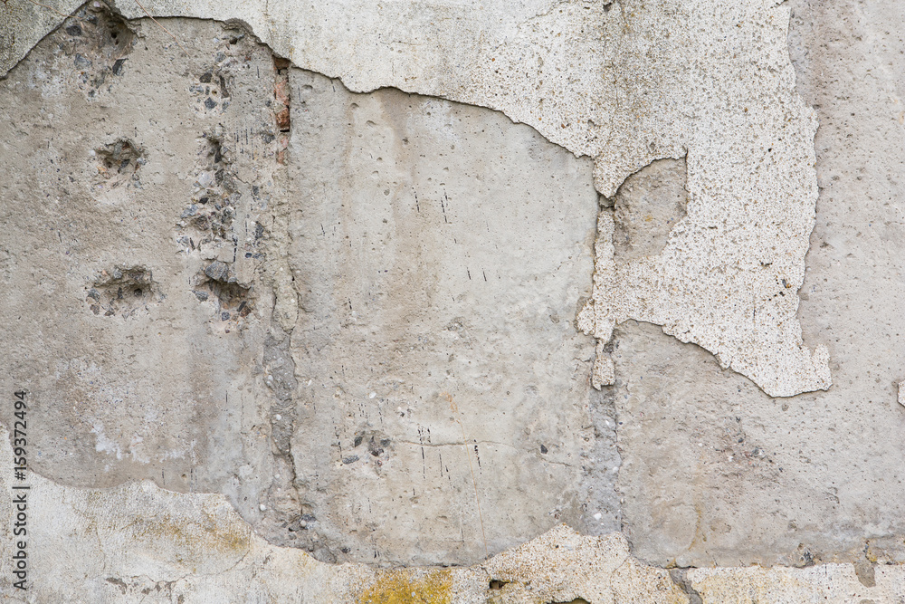 Fototapeta premium Grunge wall worn, rough masonry, cracks on the wall, plaster fell