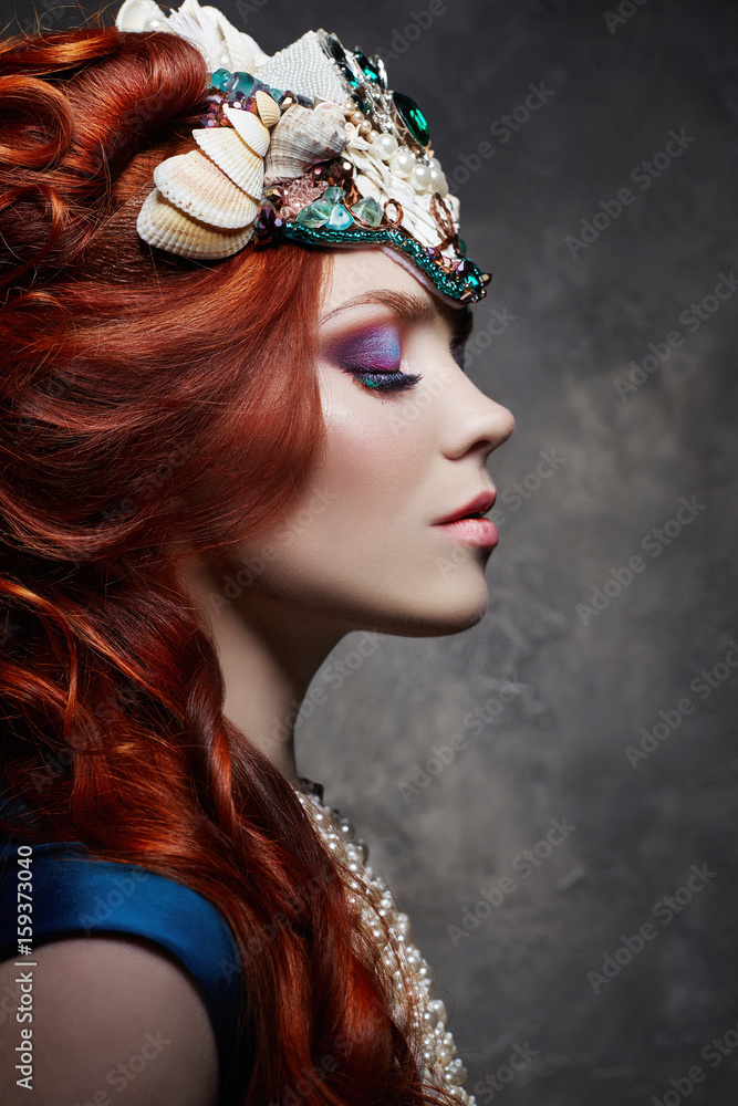 Redhead girl fabulous look, blue long dress, bright makeup and big  eyelashes. Mysterious fairy woman with