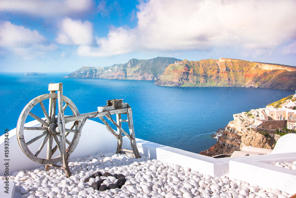 Fototapeta premium Oia town on Santorini island, Greece. Traditional and famous houses and churches with blue domes over the Caldera, Aegean sea