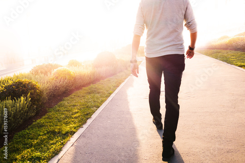 Low section of a man walking in the park